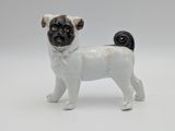 a small figurine of a pug dog on a white background