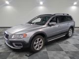 the volvo suv is parked in a clean room with a checkered floor
