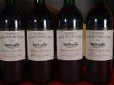 three bottles of red wine are lined up on a table