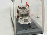 a small model of a castle in a glass case