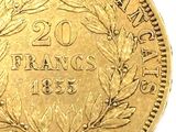 a close up of a gold coin with a wreath on it