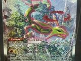 a close up of a pokemon card with a lizard on it