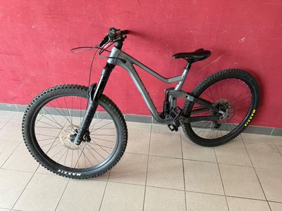a bike parked against a red wall in a room