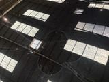 a reflection of a clock on the floor of a building
