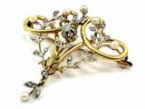an image of a close up of a brooch with pearls on it