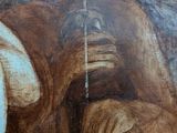 a painting of a man sitting on the ground