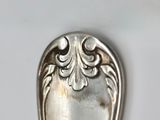 a silver spoon that is sitting on a table