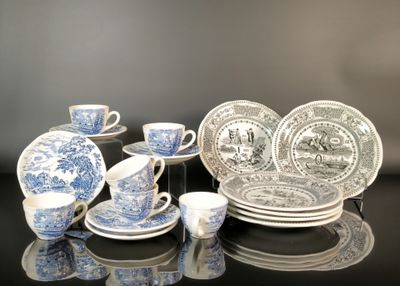 several blue and white plates and cups and saucers on a table