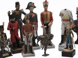 seven figurines of different types of soldiers on display