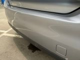 a close up of a car ' s bumper with a hole in it