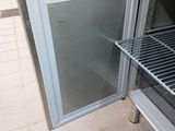 a small refrigerator with a door open in a kitchen