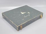 a small box with a handle on it on a white surface
