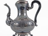 an antique silver tea pot with a black handle on a white background