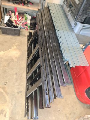 several pieces of metal are stacked on top of each other in a garage