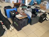 many pieces of luggage sitting on the floor in a room