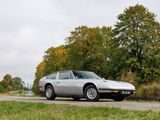 a silver car that is parked on the side of the road
