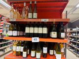 many bottles of wine on the shelves in the store