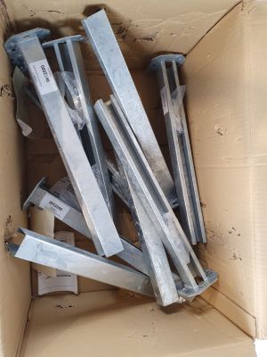 a cardboard box with a bunch of pieces of metal in it