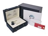 a box with a watch inside of it and a card in it