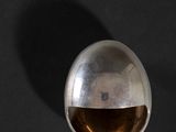 an image of a silver object on a black surface