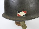 an old steel helmet with a patch on the side of it