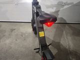 a scooter that is parked in front of a garage door