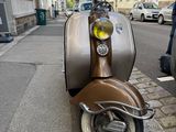 a scooter that is parked on the side of the street