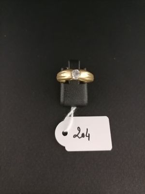 a close up of a gold ring with a diamond on top of it
