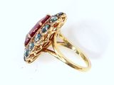 an image of a gold ring with a red and blue stone