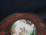 a plate with a picture of a bird and flowers on it