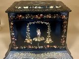 an image of a black box with flowers and birds painted on it