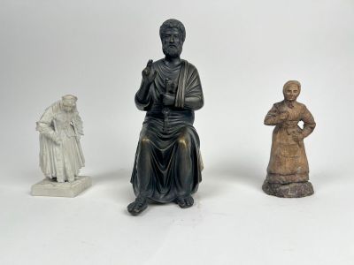trois figurines représentant un homme et une femme assis l'un à côté de l'autre