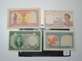 four different types of bank notes on display on a wall