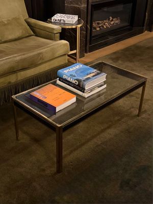 two books on a table in front of a fireplace