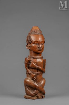 a wooden statue of a man with a hat on his head