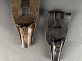pair of antique leather and brass pliers on a gray surface