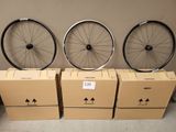 three bikes are sitting on boxes in front of a wall