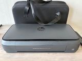 un sac noir posé sur une imprimante grise