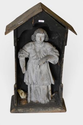 an old statue of a woman holding a bird in a birdhouse