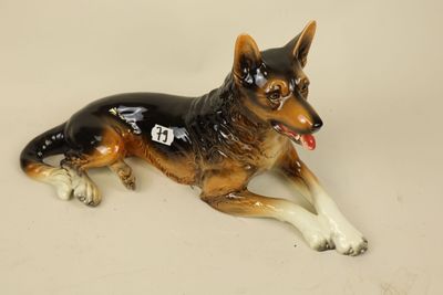 a figurine of a dog laying down on a table