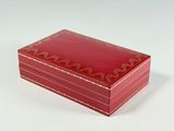 a small red box with a gold design on it