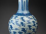 blue and white vase with a design on the outside of it