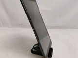 the tablet is sitting on the stand on the table