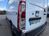 the rear end of a white van parked in a parking lot