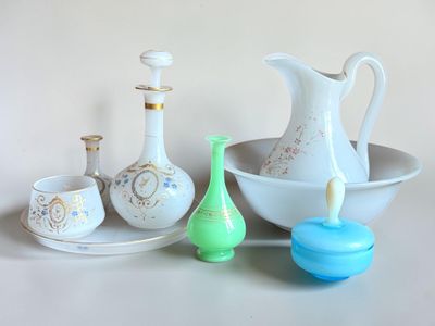 a white bowl and a bowl of vases and a bowl on a table
