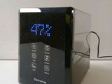a clock that is on a table with a cord