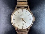 a close up of a watch on a wrist on a display case