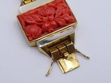 bracelet with a red stone in the middle of it and a gold clasp