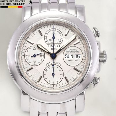 a close up of a watch on a white surface
