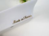 a close up of a white plate with a flower in it